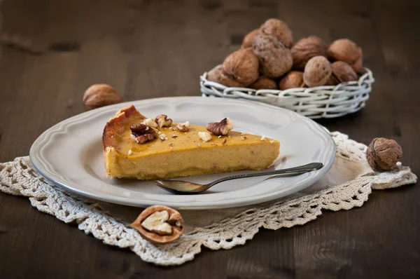 Walnut cake with pumpkin on wooden backgraund — Stock Photo, Image