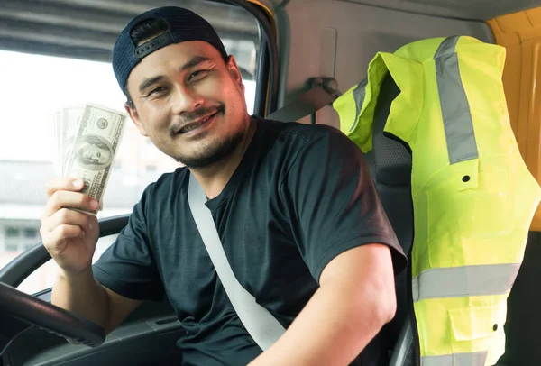 happy smiling Asian men truck driver holding banknote US dollar. laugh mature man with beard owner, business, transportation,  delivery cheerful paid cargo and service from customers confident trust.