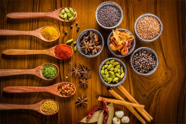 Colorful spices on wood Royalty Free Stock Images
