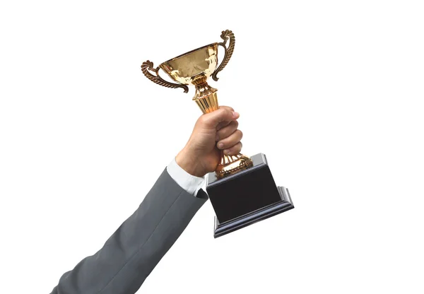 Hand of a businessman holding a golden trophy — Stock Photo, Image