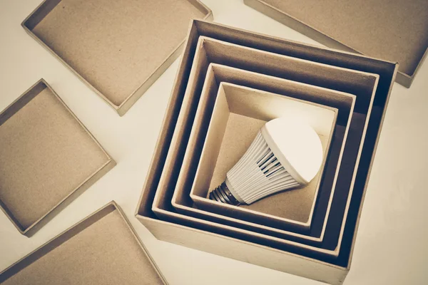 Opened cardboard boxes with light bulb — Stock Photo, Image