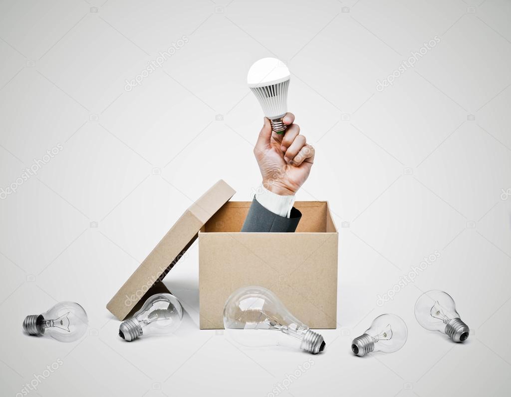 Hand of a businessman holding LED bulb