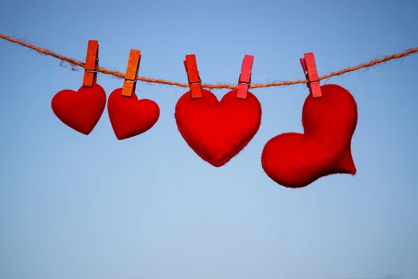 Silhouette of hearts hanging on rope — Stock Photo, Image