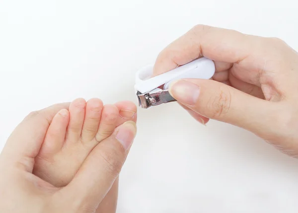 Cutting baby's toe nails on white — Stock Photo, Image