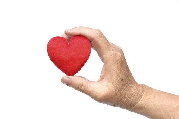 Mano sosteniendo un corazón rojo — Foto de Stock