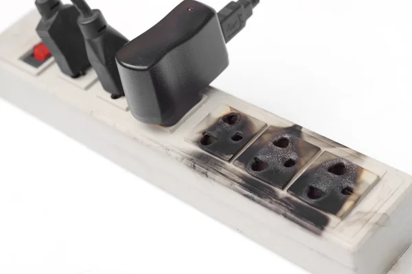 Burnt surge protector with adapters — Stock Photo, Image