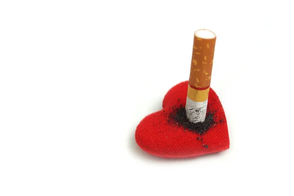 Cigarette burnt a red heart on white — Stock Photo, Image