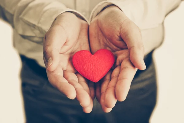 Businessman giving a red heart — Stock Photo, Image