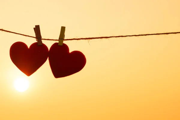 Silhouette of hearts hanging on rope — Stock Photo, Image