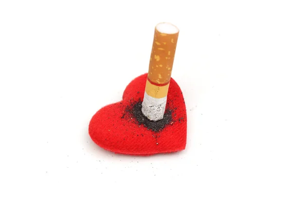 Cigarette burnt a red heart on white — Stock Photo, Image