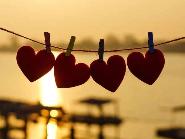 Silhouette of hearts hanging on rope — Stock Photo, Image