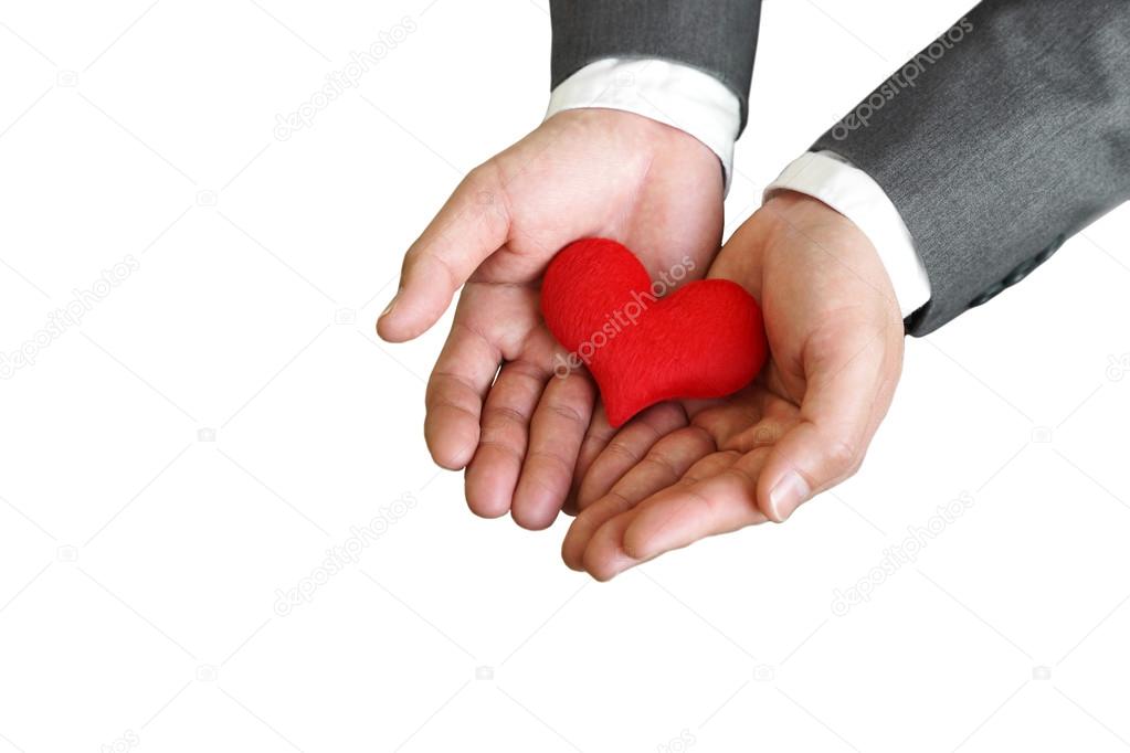 Businessman giving a red heart isolated