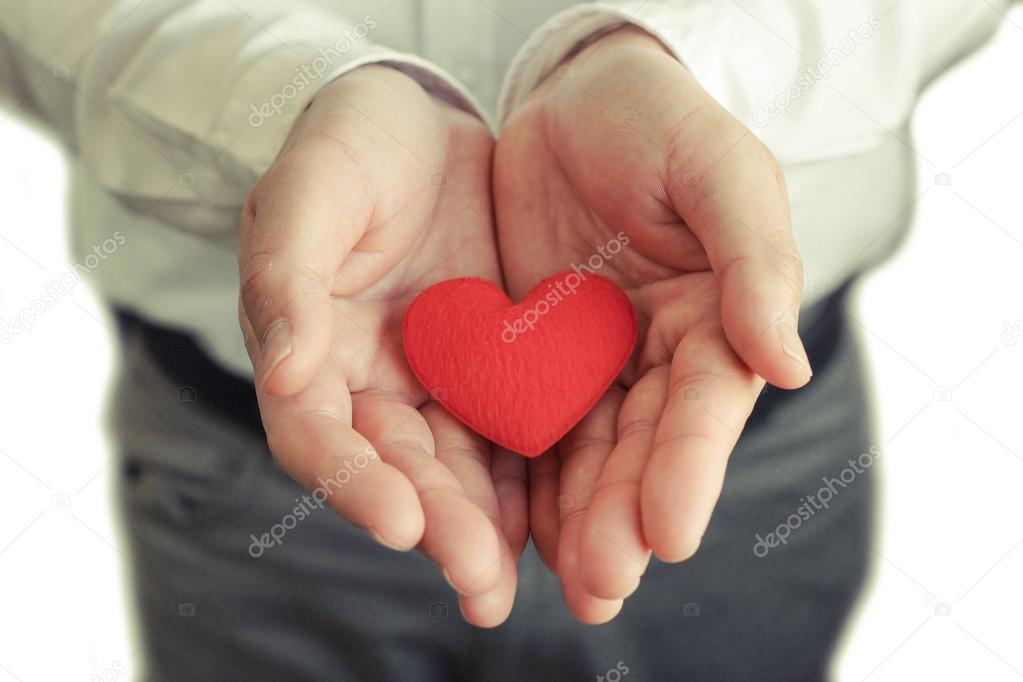 Businessman giving a red heart