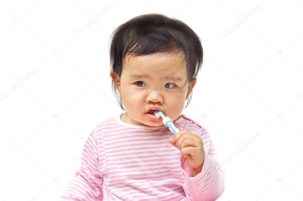 Young Asian baby brushing teeth