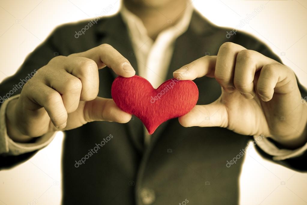 Businessman gives a red heart