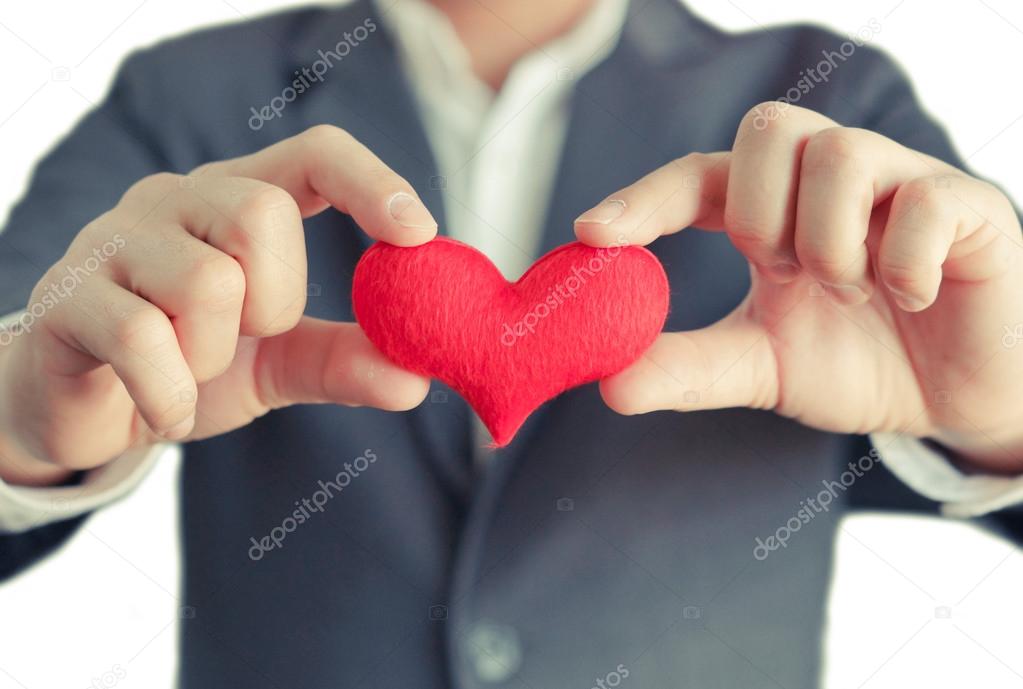 Businessman gives a red heart