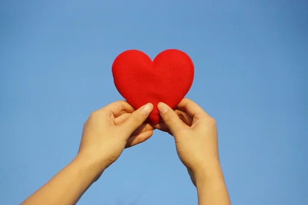 Hands holding a red heart — Stock Photo, Image