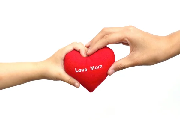 Hands holding a toy red heart — Stock Photo, Image