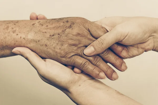 Female hands touching old female hand — Stock Photo, Image