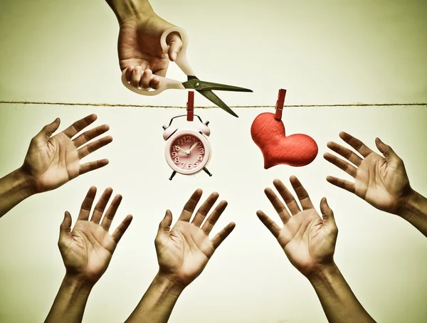 Hand with scissors trying to cut a rope — Stock Photo, Image