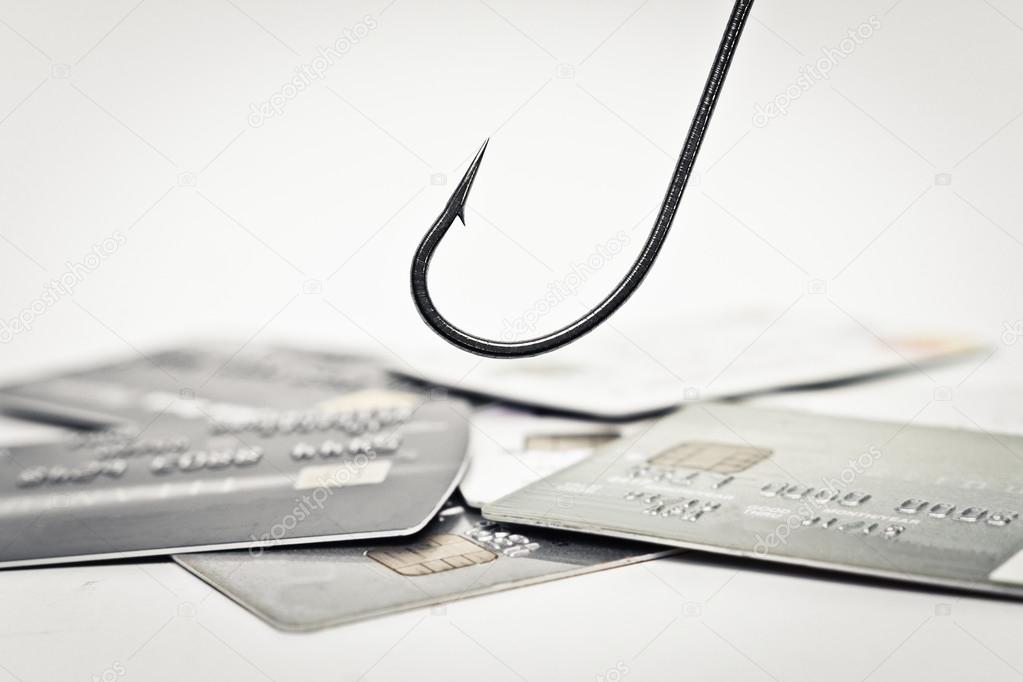 fish hook over a pile of credit cards