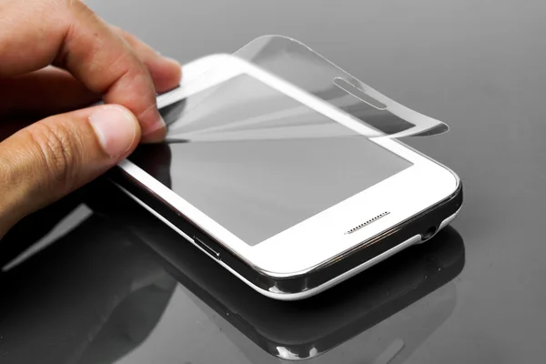 Hand laying scratch protective film — Stock Photo, Image