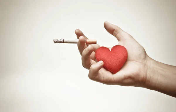 Male hand holding a cigarette — Stock Photo, Image