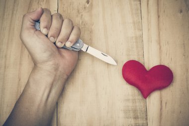 knife stabbing into a red heart