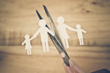 Scissors cutting paper cut of family