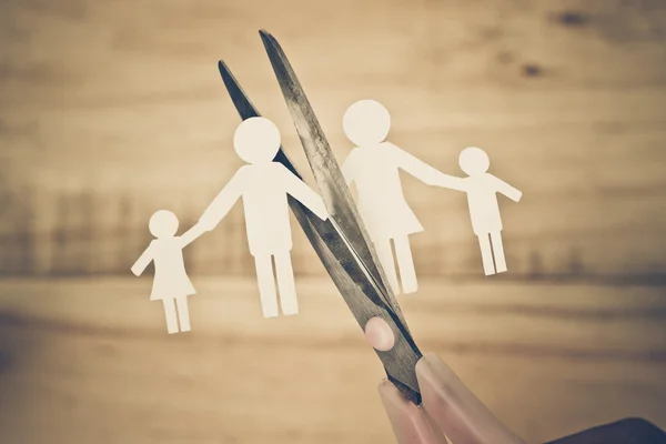 Scissors cutting paper cut of family — Stock Fotó