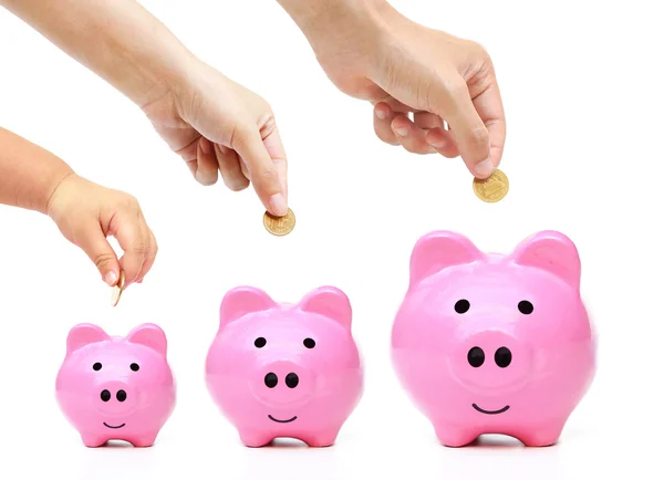 Familie doen besparen van geld in groene piggy banks — Stockfoto