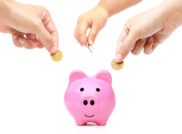 People in the family doing saving money in a pink piggybank Stock Photo