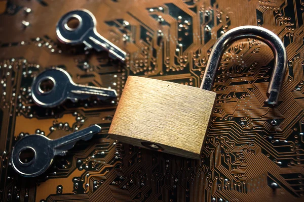 Security lock on circuit board with keys — Stock Photo, Image