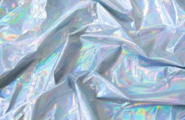 Holographic Y2K iridescent fabric background, Crumpled holographic fabric with iridescent glow in pastel tones. Trendy Y2K aesthetic background with dreamy metallic texture and soft light reflections