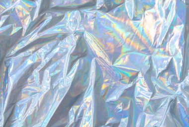 Parlak yanardöner yüzeyi ve renkli yansımaları olan holografik dokuyu kapat. Moda, tasarım ve yaratıcı projeler için moda tekstil arka planı