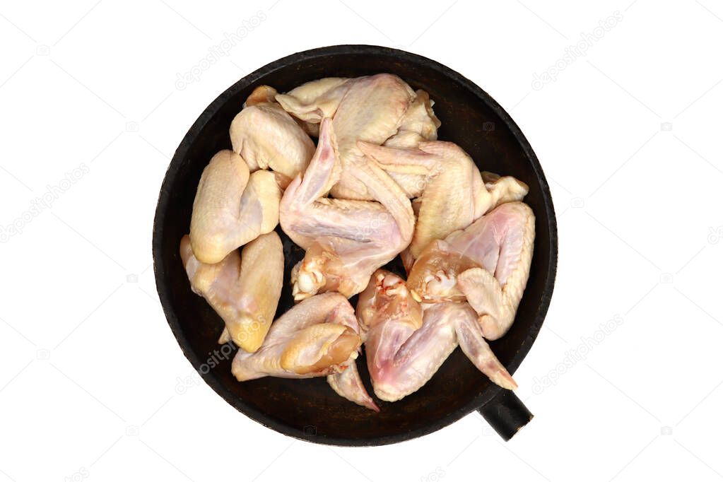 Raw Chicken wings in a pan isolated on white, top view