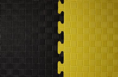 Siyah ve sarı yapboz, kauçuk minder, arkaplan, doku yakın çekim