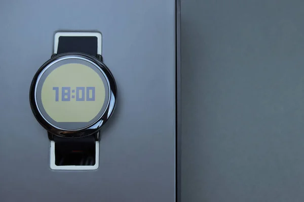 New smart watch in a box on a gray background. Close-up