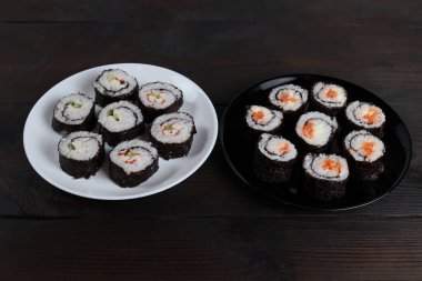 Tahta bir masada taze, lezzetli suşi ruloları.