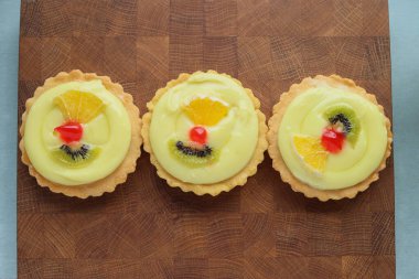 Panakota keki ve tahtanın üzerinde meyve sepeti.