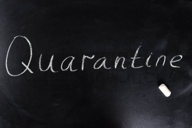 Okul karantina konsepti. Öğretmen kelimeyi tahtaya tebeşirle yazdı.