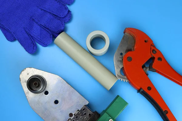 Plumbing tools on a blue background