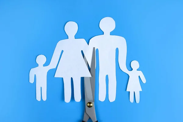Scissors cut paper family. The concept of divorce, family preservation