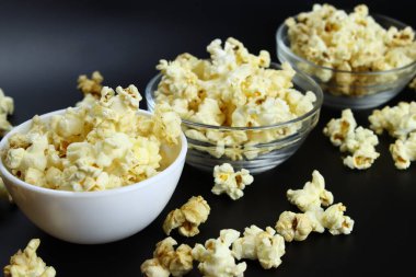 caramel popcorn in bowls on a black background