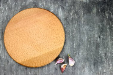 Wooden cutting board and garlic