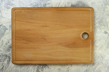 Wooden cutting board on a gray table