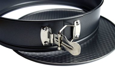 Parçalanmış yuvarlak metal pişirme kabı ve beyaz üzerine yapışmayan kaplama.