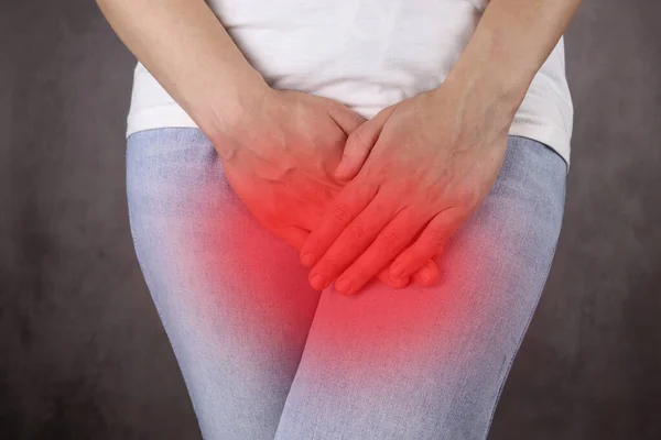 woman holds the lower abdomen, the concept of menstrual pain, diseases of female reproductive organs