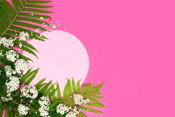 empty circle on a background of green leaves and flowers. Tropic summer mock-up.