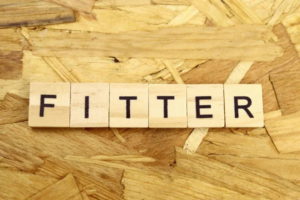Fitter Λέξη Από Ξύλινα Γράμματα — Φωτογραφία Αρχείου